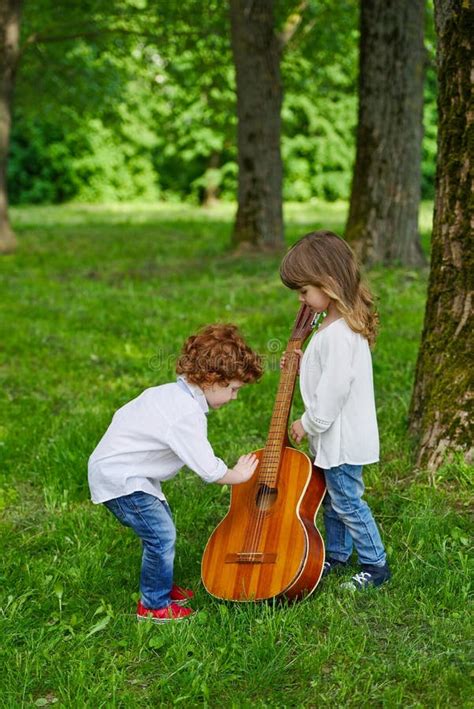 Cute Children Playing Guitar Stock Photo - Image of caucasian, family: 73326272