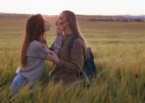 Two Women Holding Hands At Sunset In The Field Photograph by Cavan ...