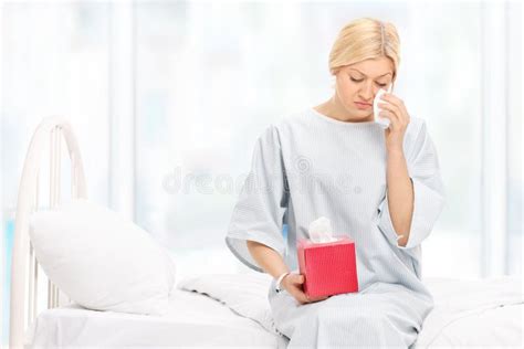 Sad Female Patient Crying Seated On A Hospital Bed Stock Photo - Image: 52559890