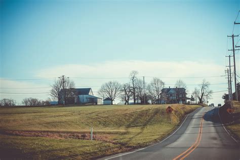 Free stock photo of farmhouse, paved road, road signs