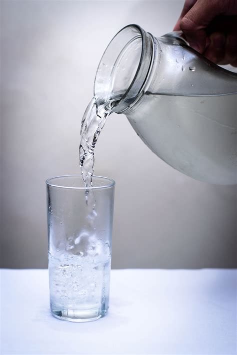 Clear Glass Pitcher Pouring Water on Clear Drinking Glass · Free Stock Photo