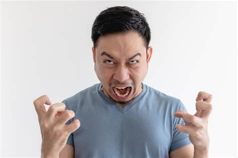 Premium Photo | Angry and mad face of man in blue t-shirt on isolated wall.