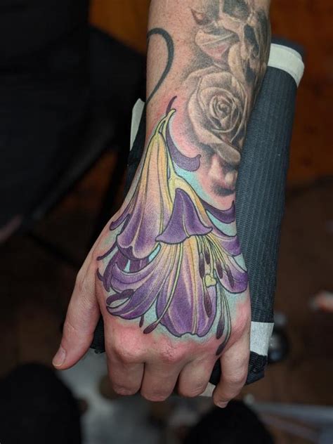 Color flower hand tattoo by Kaija Heitland: TattooNOW