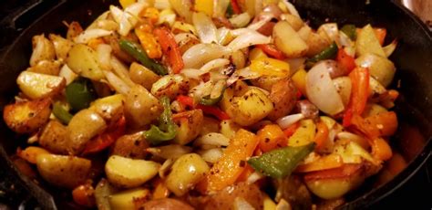 Cooked up a mess of home fries with peppers, onions, and garlic. : castiron