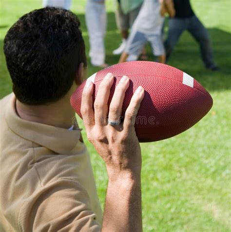 Man Throwing Football To Group of People Back View. Stock Photo - Image ...