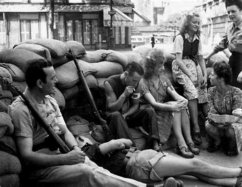 Members of the French Resistance rest against a barricade during the Battle for Paris (1944 ...