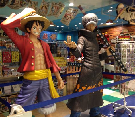 two figurines that are standing in a store display case, one is wearing a pirate costume and the ...