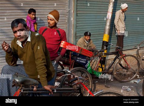 Indian rickshaw drivers wait for customers in New Delhi, India, early Friday, Dec. 16,2011. The ...