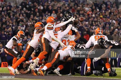 Quarterback Lamar Jackson of the Baltimore Ravens fumbles the ball as ...