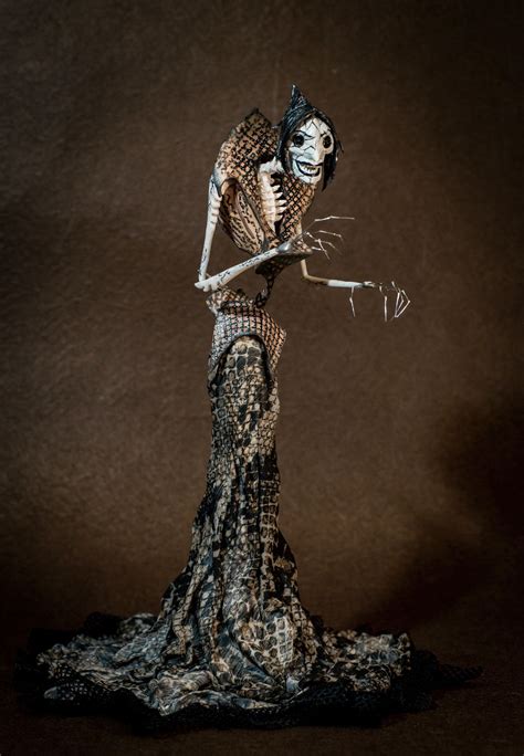 a skeleton doll holding a plant in its hand