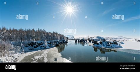 View of volcanic rock formation in the water, Lake Mývatn in winter, Höfði Peninsula, Iceland ...