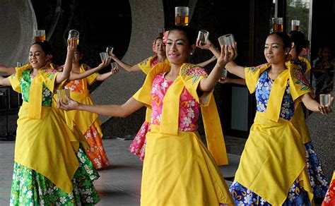 Filipino dancers perform the Binasuan, a dance using glasses with liquid, during the Pasinaya ...