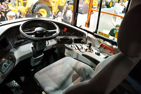 the interior of a bus with steering wheel and dashboard