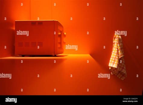 orange microwave at orange kitchen with white towel. technology concept ...