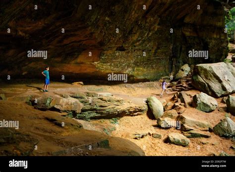 Distant view of two children hiking through sandstone gorge in summer ...