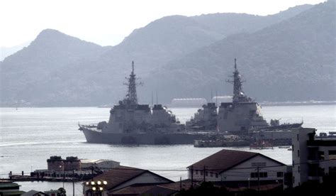 Japanese vessels are shown anchored at Sasebo Naval Base in Nagasaki ...