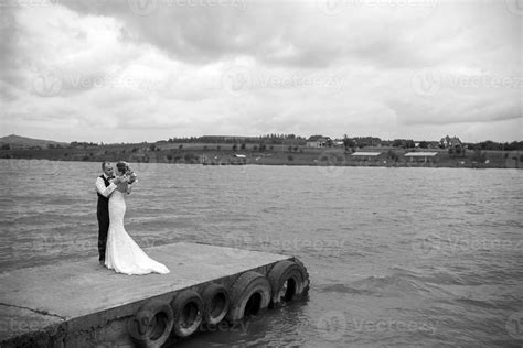 couple on pier on wedding day 11532405 Stock Photo at Vecteezy