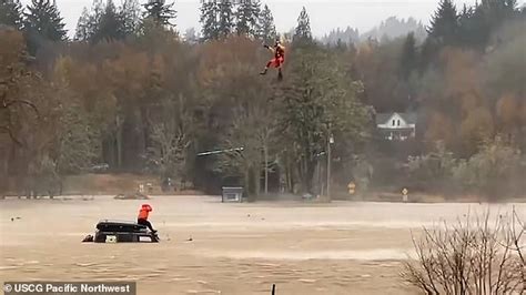 Incredible moment Washington state Coast Guard hangs below helicopter to save ... trends now