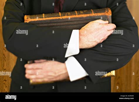 Man holding large book Stock Photo - Alamy