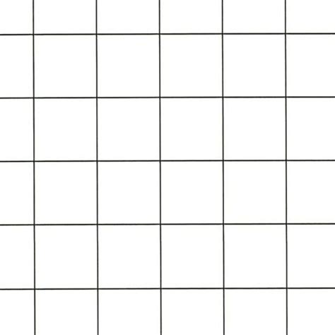 a white tiled wall with black squares on it