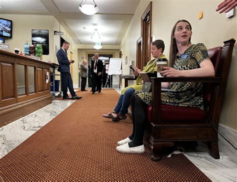 Banned transgender lawmaker working from bench outside Montana House ...