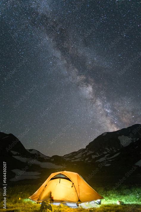 camp in mountain with under starry night sky with Milky Way Stock Photo ...