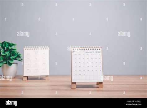 Desktop calendar for 2023 on a desk beige and white background. plans and goals on next year ...