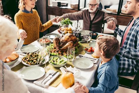 family holding hands and praying on thanksgiving Stock Photo | Adobe Stock