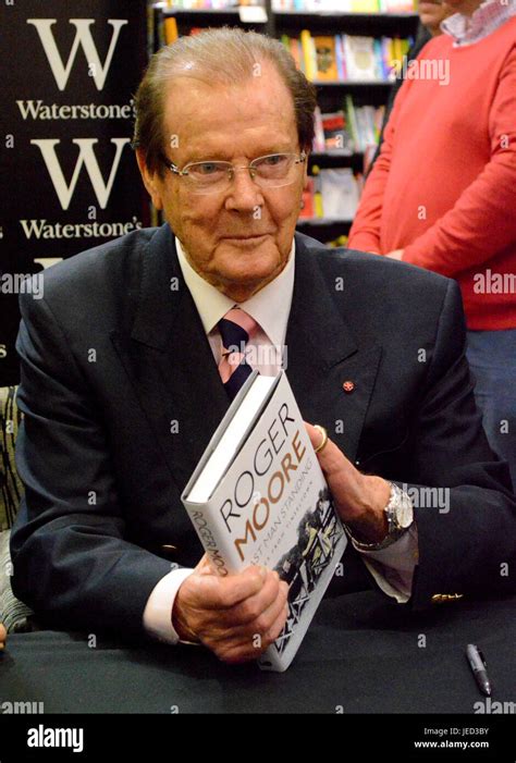 Sir Roger Moore signing copies of his autobiography 'Last Man Standing: Tales from Tinseltown ...