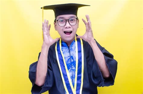 Premium Photo | Happy asian male student in graduation uniform cap and ...