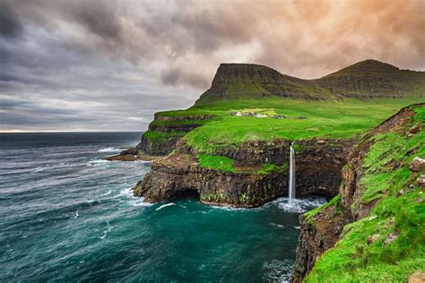 Gasadalur village and its iconic waterfall, Vagar, Faroe Islands, Denmark - miroslav_1/iStock ...