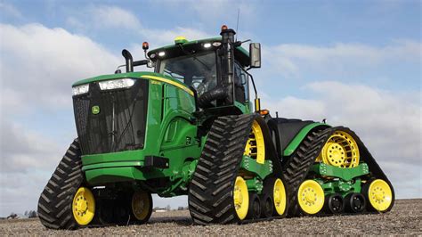 A 9R Family tractor facing to the left in a field John Deere Equipment, Old Farm Equipment ...