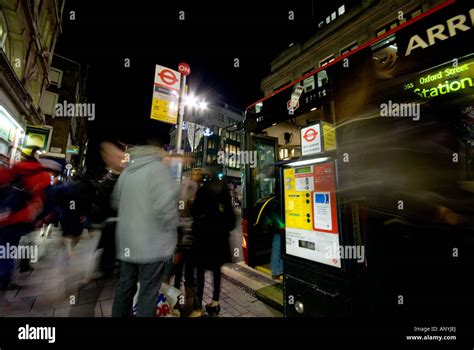 red bus stop at night london Stock Photo - Alamy