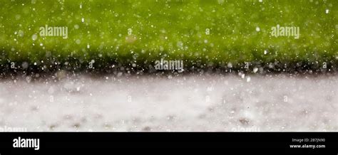 Heavy rain splashing in a puddle Stock Photo - Alamy