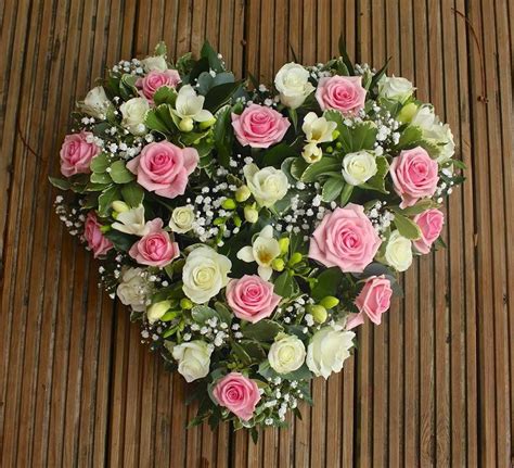 Gentle and feminine heart decorated in pink and white roses and freesia ...