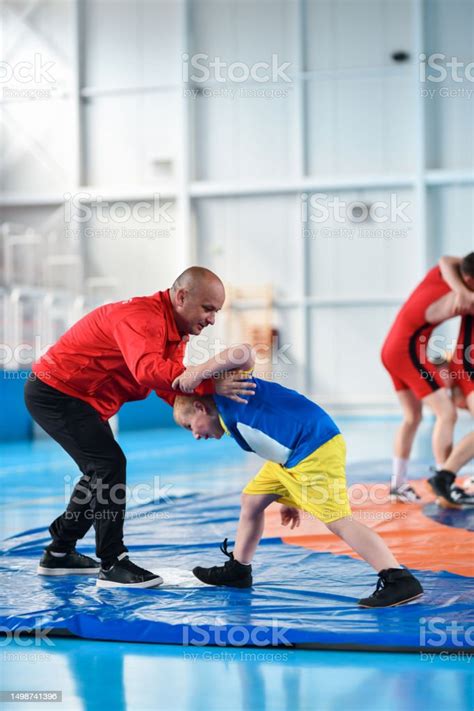 Young Child Learning Wrestling Moves With Coach Stock Photo - Download ...