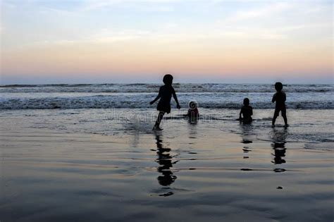 Silhouette of Young Kids Playing at the Beach during Sunset Stock Image - Image of seashore ...