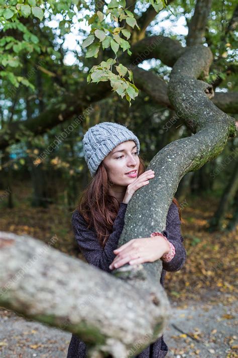 Woman hugging a tree - Stock Image - C037/6974 - Science Photo Library