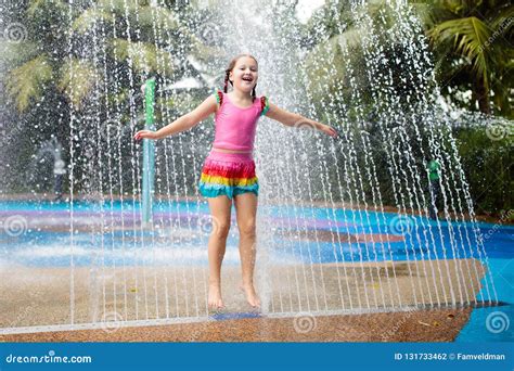 Kids Play in Aqua Park. Children at Water Playground of Tropical Amusement Park. Little Girl at ...