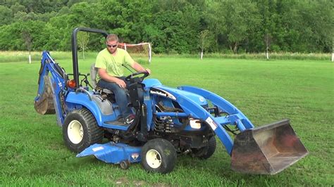 2007 NEW HOLLAND TZ18DA COMPACT TRACTOR WITH LOADER, MOWER, BACKHOE - YouTube