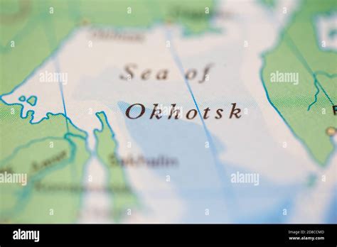 Shallow depth of field focus on geographical map location of Sea of Okhotsk off coast of Russia ...