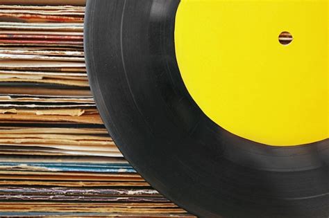 Premium Photo | Old vinyl records with yellow label on paper background