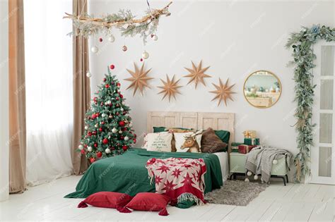 Premium Photo | Stylish christmas decorated bedroom in classic red, white and green colors.