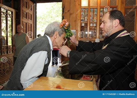 Christian Priest Gives People To Kiss the Cross and Blesses Them with Holy Water on a Big Church ...