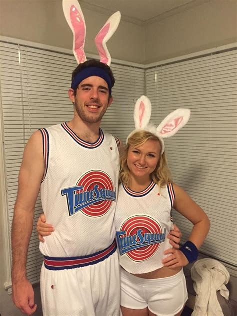 a man and woman in bunny ears standing next to each other wearing basketball uniforms with the ...