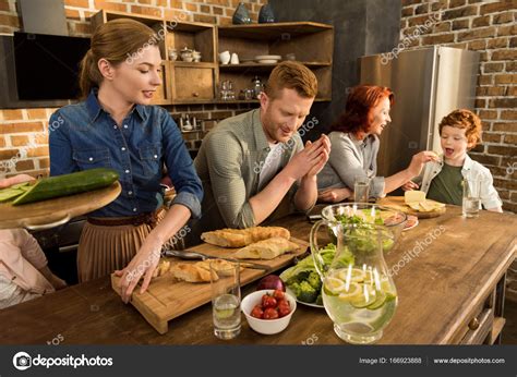 Family cooking dinner at home — Stock Photo © DimaBaranow #166923888