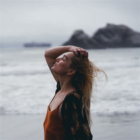 stylish woman posing on beach Stock Photo free download