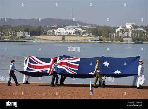 Defence personnel march past with the Australian flag during an ...