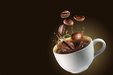 Premium Photo | Coffee beans drop on splash coffee cup background