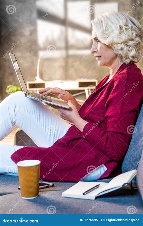 Senior Woman Using Laptop Sitting Stock Image - Image of homeoffice, blogger: 127659513